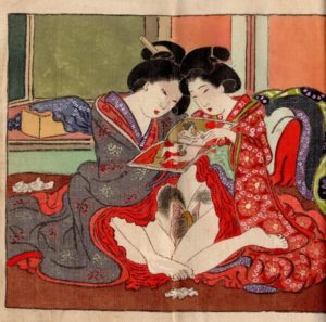 Lesbians experimenting with a harigata while looking at a shunga book.