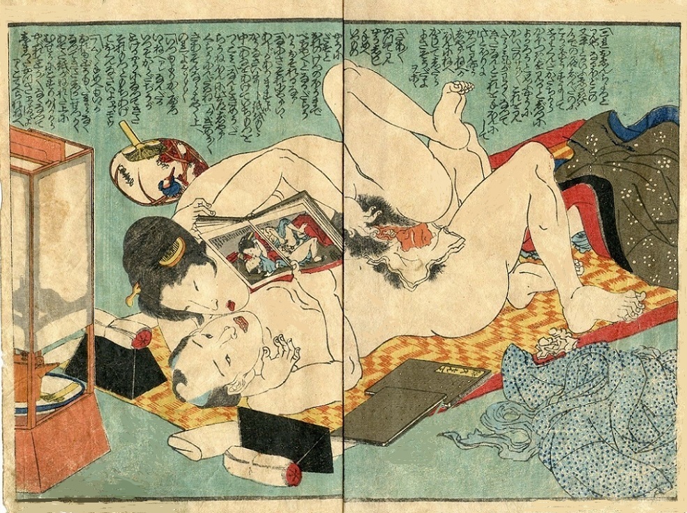 Copulating couple mimicking a pose in a shunga book