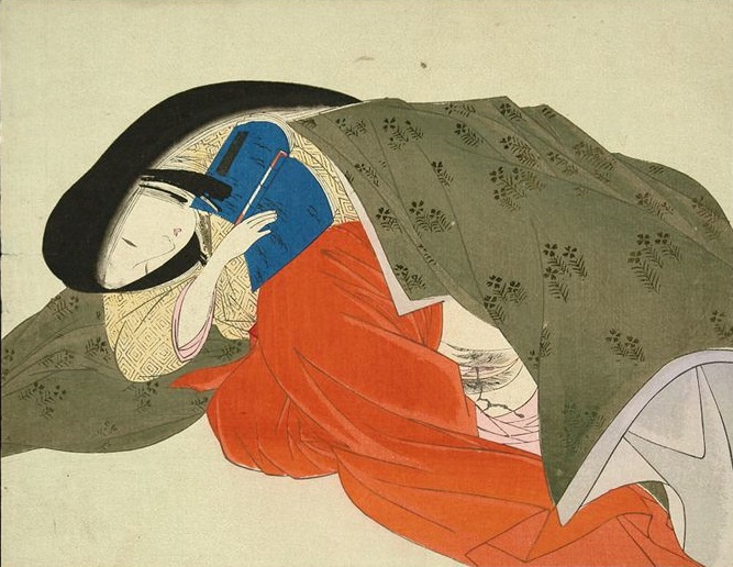 Sensual girl aroused by the contents of a shunga book