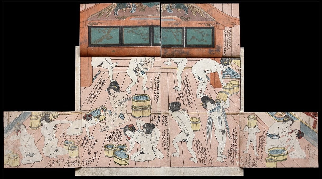 A crowded bathhouse with multiple Japanese women and their offspring bathing.