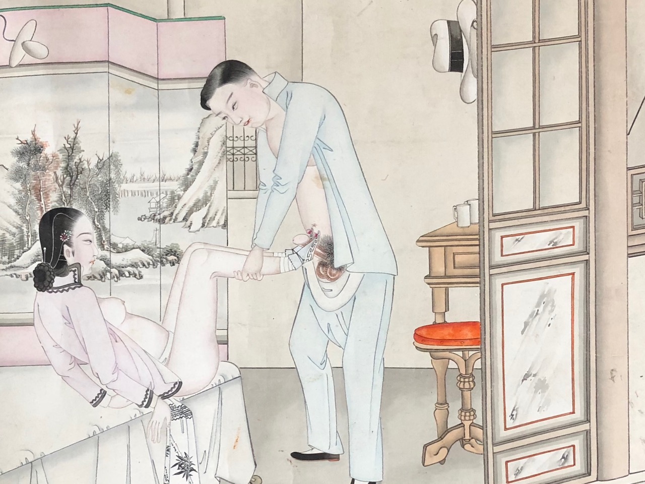 chinese erotic art with Girl massaging her lover's private parts with her feet. His white Panama hat hanging on the door.