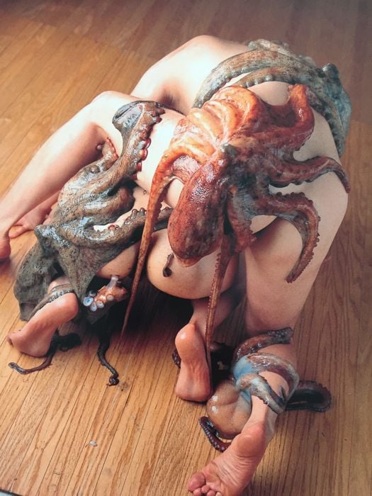 octopuses sucking on the back of a nude girl by Daikichi Amano