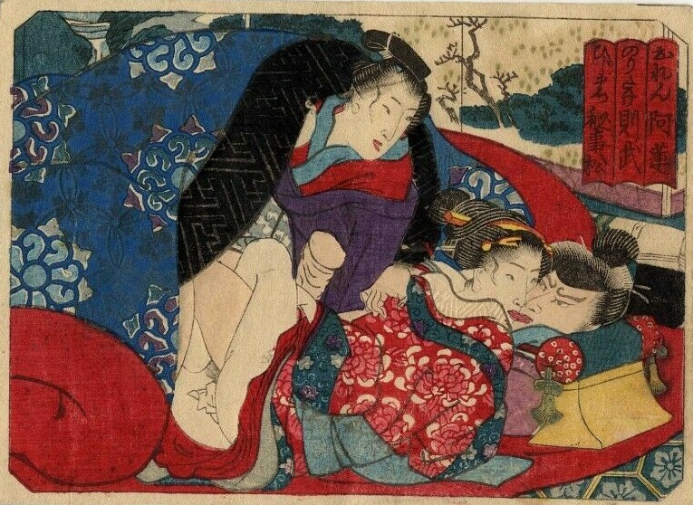 A dominant male with a determined expression on his face is tongue-kissing a young courtesan while resting his head on a taka-makura (geisha pillow). They just finished their love-making (look for the tissue behind the legs of the girl) but he maintained his erection. They are watched from underneath the blanket by a young male attendant