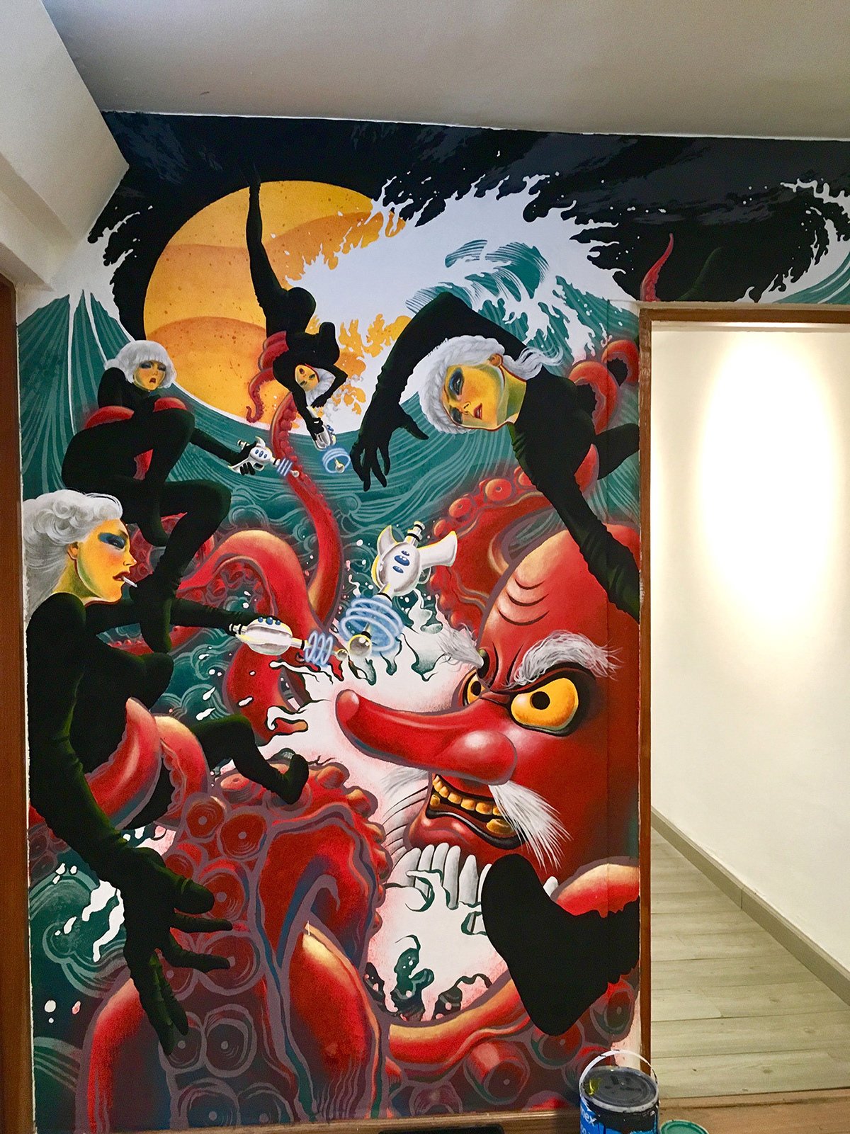 mural design with black female figures in the waves with red octopus